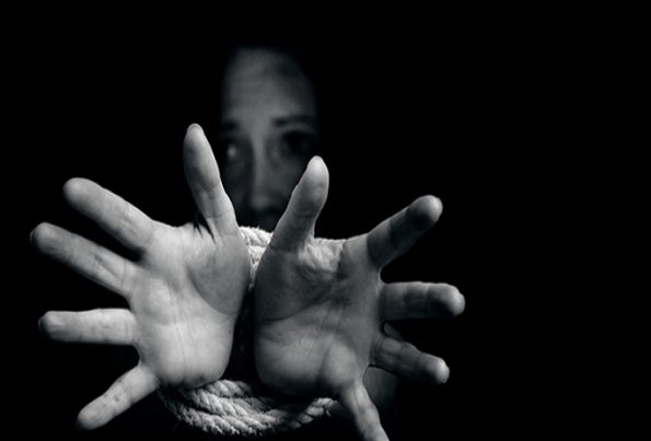 Missing kidnapped, abused, hostage, victim woman with hands tied up with rope in emotional stress and pain, afraid, restricted, trapped, call for help, struggle, terrified, locked in a cage cell.